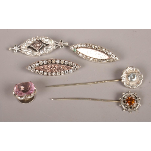 264 - A small quantity of silver jewellery. Including three brooches, two stick pins and a stone set stud.