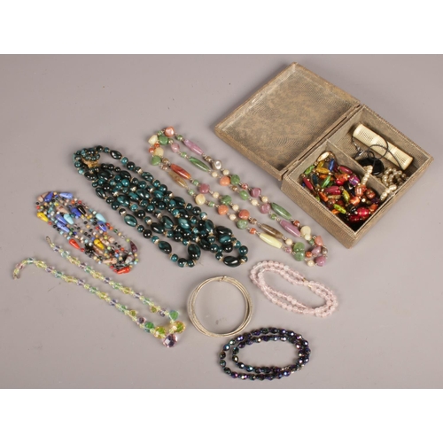 62 - A box of costume jewellery. Including mostly beads and bangles, etc.