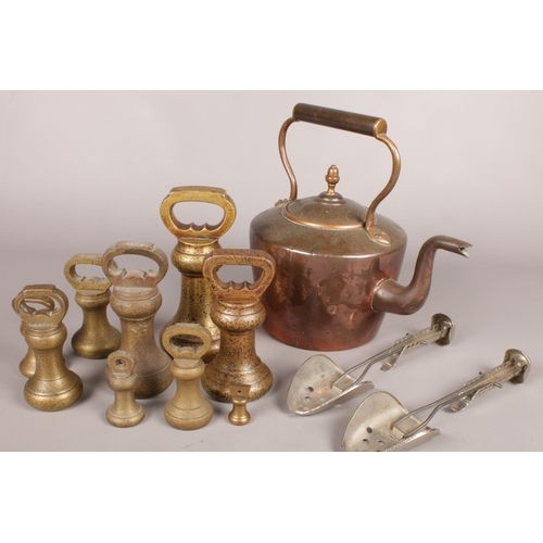 72 - A quantity of metalwares. Including set of brass butchers weights, shoe stretchers, copper kettle, e... 