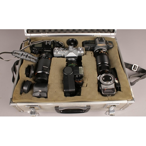 388 - A metal camera carry case with contents. Including Canon T70 camera, Canon EOS 650 camera, Zenit-E c... 