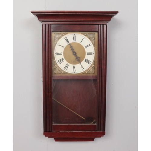 399 - An Acctim Mahogany cased wall clock with pendulum. H: 54cm, W: 33cm.