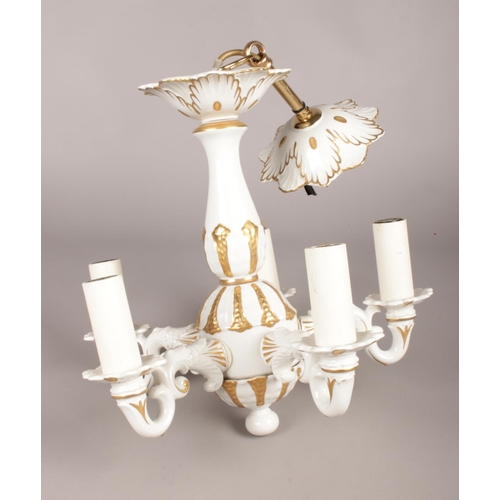 416 - A five armed ceramic chandelier decorated in white and gold. H: 52cm.