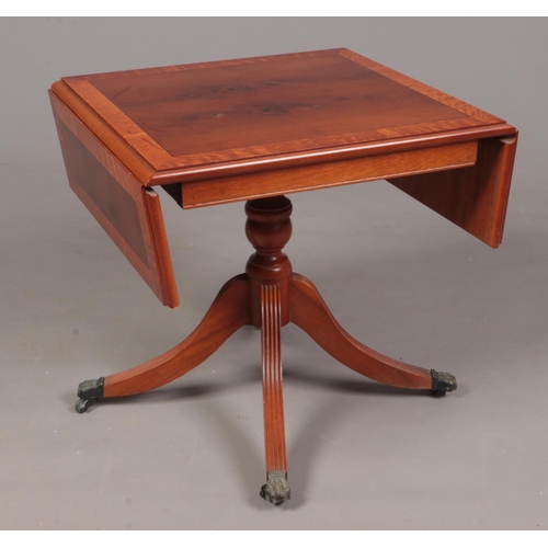 331 - A yew wood dropleaf sofa table.