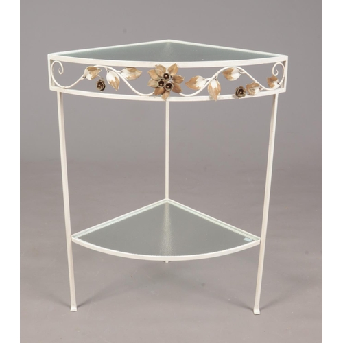 348 - A painted wrought iron corner glass topped table. Comprising of a lower shelf with floral decoration... 