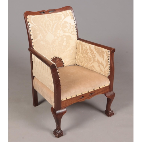 350 - An Oak framed and carved upholstered chair. Comprising of ball and claw front feet and ivory upholst... 