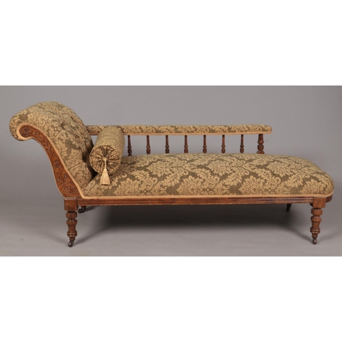 354 - A Victorian mahogany chaise lounge. With deep button upholstery and turned supports.