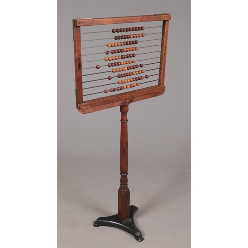 357 - A Victorian school abacus. With turned column and cast iron tripod base.