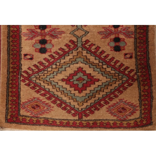 397 - A light brown ground carpet runner with Aztec design. L: 182cm, W:60cm.