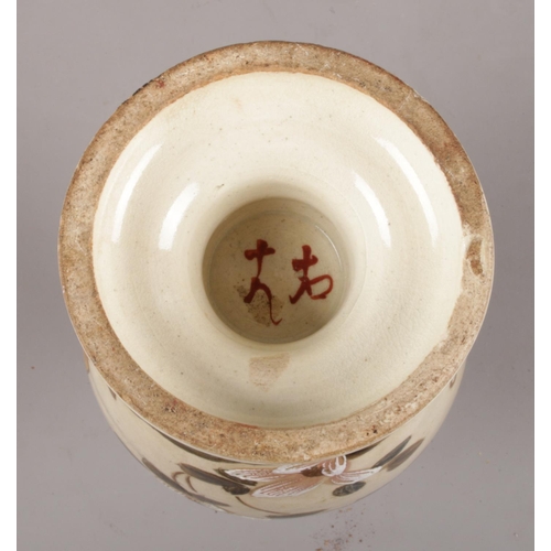 64 - Two Japanese ceramic vases. To include a Satsuma style vase depicting a warrior, along with a vase d... 