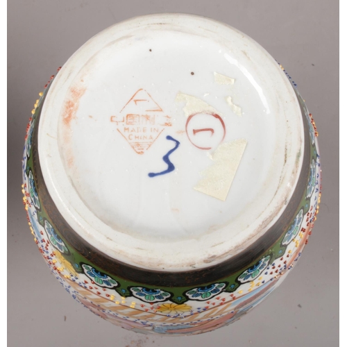 64 - Two Japanese ceramic vases. To include a Satsuma style vase depicting a warrior, along with a vase d... 