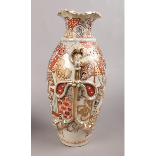 69 - A pair of Satsuma style vases, depicting warriors decorated with twin-rope twist handles. Makers mar... 