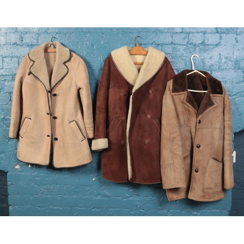 495 - Three sheepskin coats. To include a Richard Draper light brown with brown piping Size 12 - a George ... 