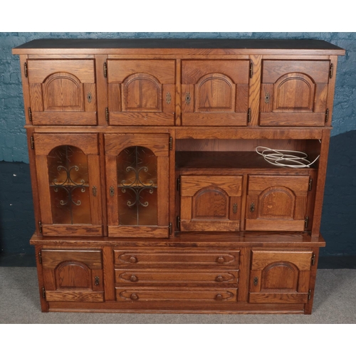 587 - An oak fronted stacking display unit, with drawers and shelved sections. Height: 187cm, Width: 201cm... 