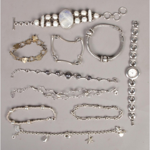 373 - A collection of silver jewellery. Includes Accurist quartz bracelet watch and nine other bracelets.