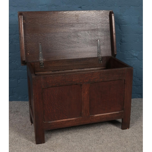 455 - An early 20th Century oak panelled coffer with hinged lid. H: 53cm, W:82cm D: 43cm.