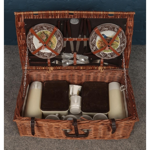 246 - A Brexton Picnic Set, contained within a wicket hamper basket. Appears to be complete.