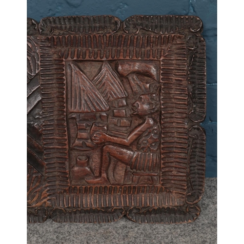 314 - A large carved hardwood African plaque. H:37.5cm W:90cm.