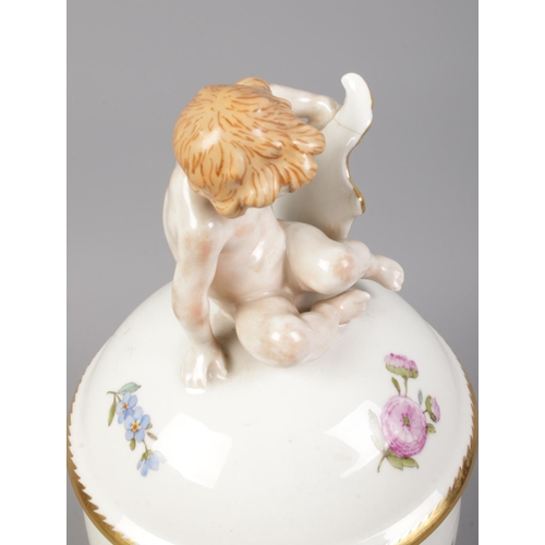 390 - A Royal Copenhagen 'egg shaped' lidded vase, topped with a cherub, in pattern 493-1754.