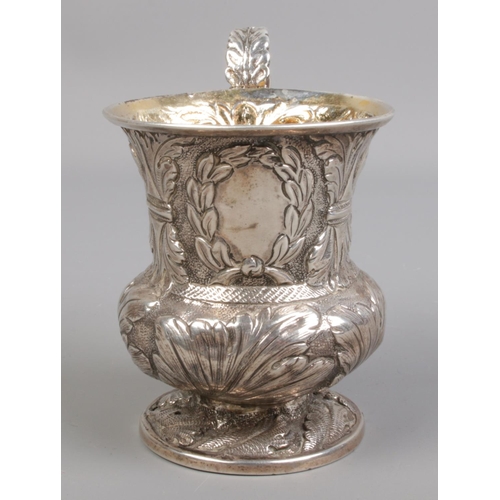 410 - A George IV silver Christening mug with repousse decoration and gilt interior. Assayed London 1827 b... 