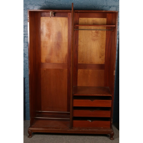 431 - A mahogany double wardrobe. With one mirrored door and fitted interior.