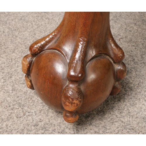 432 - A Victorian carved mahogany wind out dining table. With two extra leaves. Raised on carved ball and ... 