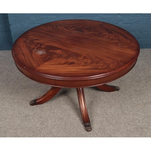 474 - A Mahogany circular coffee table resting on four legs with claw feet and concealed draw. H: 53cm W: ... 