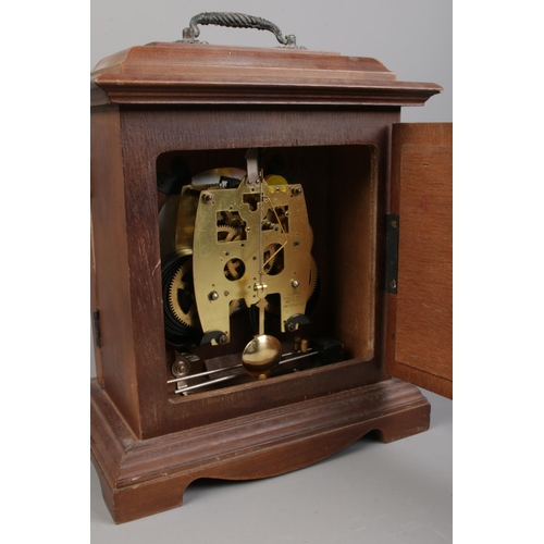 159 - A mahogany 31 day mantle clock. Comes with key and pendulum. H:31cm W: 25.5cm.