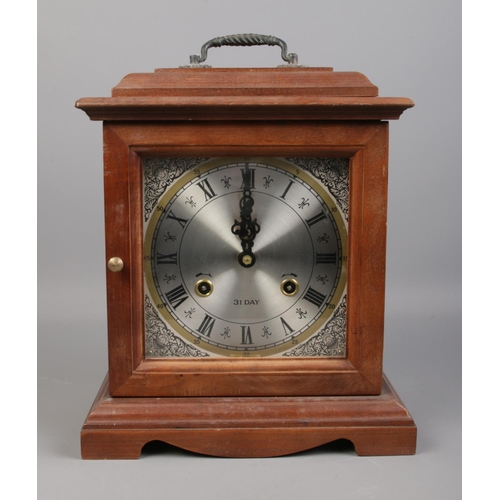 159 - A mahogany 31 day mantle clock. Comes with key and pendulum. H:31cm W: 25.5cm.