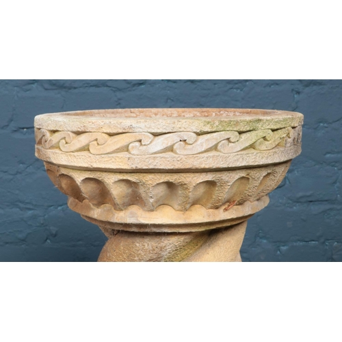 288 - A pair of cast stone bird baths of circular form, with twisted pillars raised on square plinths with... 