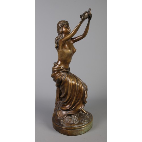 166 - A cast bronze figure of a seated woman with a dove. H: 51.5cm.