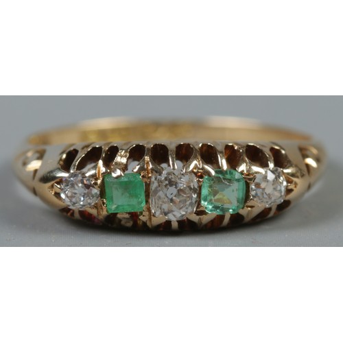 355 - An 18ct gold diamond and emerald five stone ring. Size L. 2.92g.