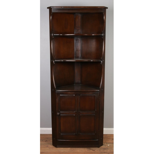 531 - An Ercol Old Colonial corner cupboard with open top and cupboard base.