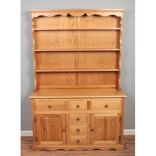 534 - A pine kitchen dresser. (203cm x 138cm)