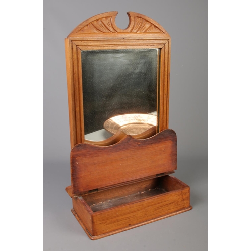 285 - A carved hall way mirror with with pull up compartment and copper coloured stamped charger plate. Mi... 