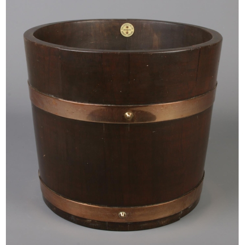 520 - A brass bound mahogany barrel by R.A Lister & Co Ltd. Height 27cm, Diameter 31cm.