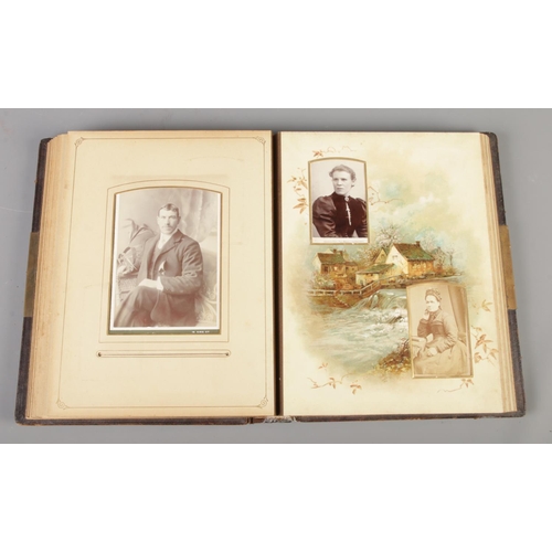 306 - A large Victorian family bible, together with two Victorian leather photo albums.