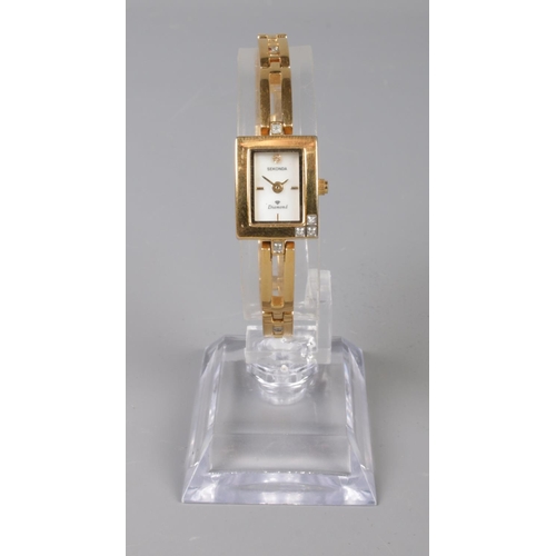 381 - A ladies yellow metal Sekonda quartz wristwatch, set with small diamond highlights to the corner of ... 