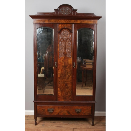 521 - A Victorian mahogany and walnut mirror front wardrobe.