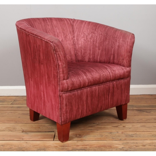 525 - A bedroom tub chair, with patterned upholstery and tapered feet.