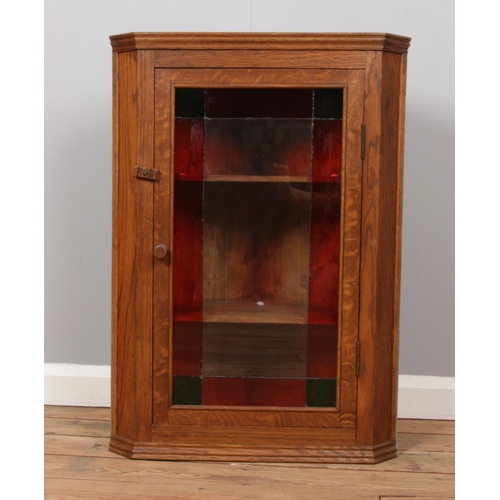 535 - A oak stained glass corner display cabinet. ( 81cm height 60cm width 41cm depth)