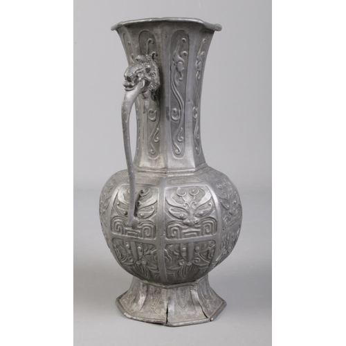 102 - An antique Chinese pewter twin handle vase, decorated with Dog of Fo. 20.5cm.