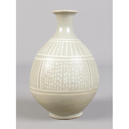 106 - A Korean celadon vase in wooden box. Vase 16cm.