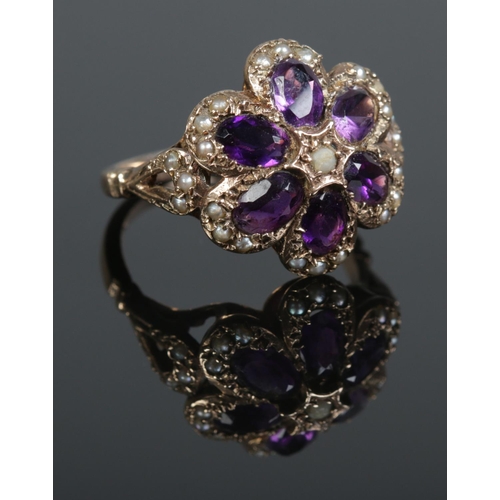 115 - A vintage 9ct gold amethyst and seed pearl floriform ring. Assayed London 1974. Size R. 5.85g.