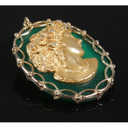 117 - A 9ct gold cameo pendant. The gold relief cameo depicting a maiden with diamond highlights, set upon... 