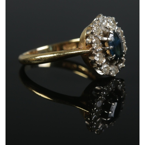 119 - An 18ct gold sapphire and diamond halo set ring. Size O. 5.2g. Sapphire size approximately 0.9cm x 0... 