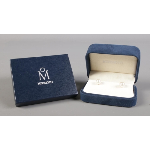 120 - A boxed pair of Mikimoto 18ct gold and pearl earrings. Diameter of pearl 6mm.