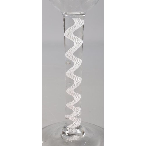 23 - An 18th century wine glass with opaque air twist stem. 15.5cm.