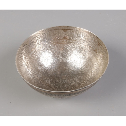 32 - An Eastern silver bowl with etched decoration. 12cm diameter. 130g.