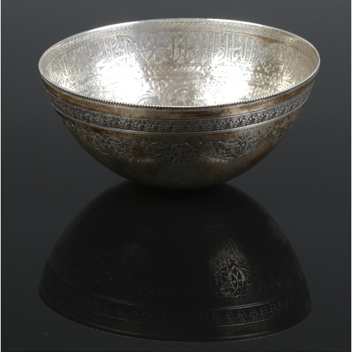 32 - An Eastern silver bowl with etched decoration. 12cm diameter. 130g.