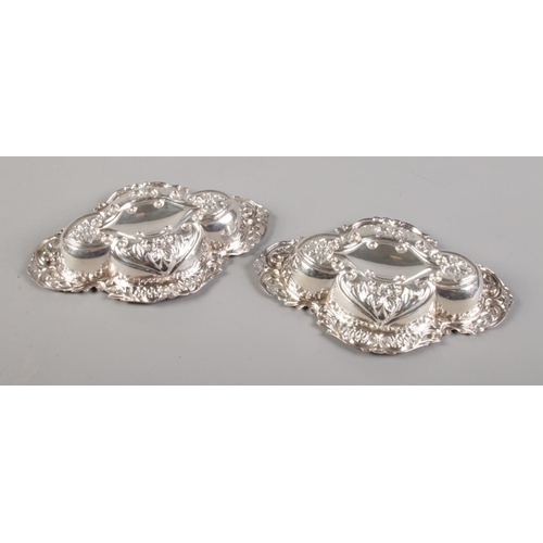 33 - A pair of Edwardian silver dishes with repousse floral decoration. Assayed Birmingham 1903 by Cooper... 